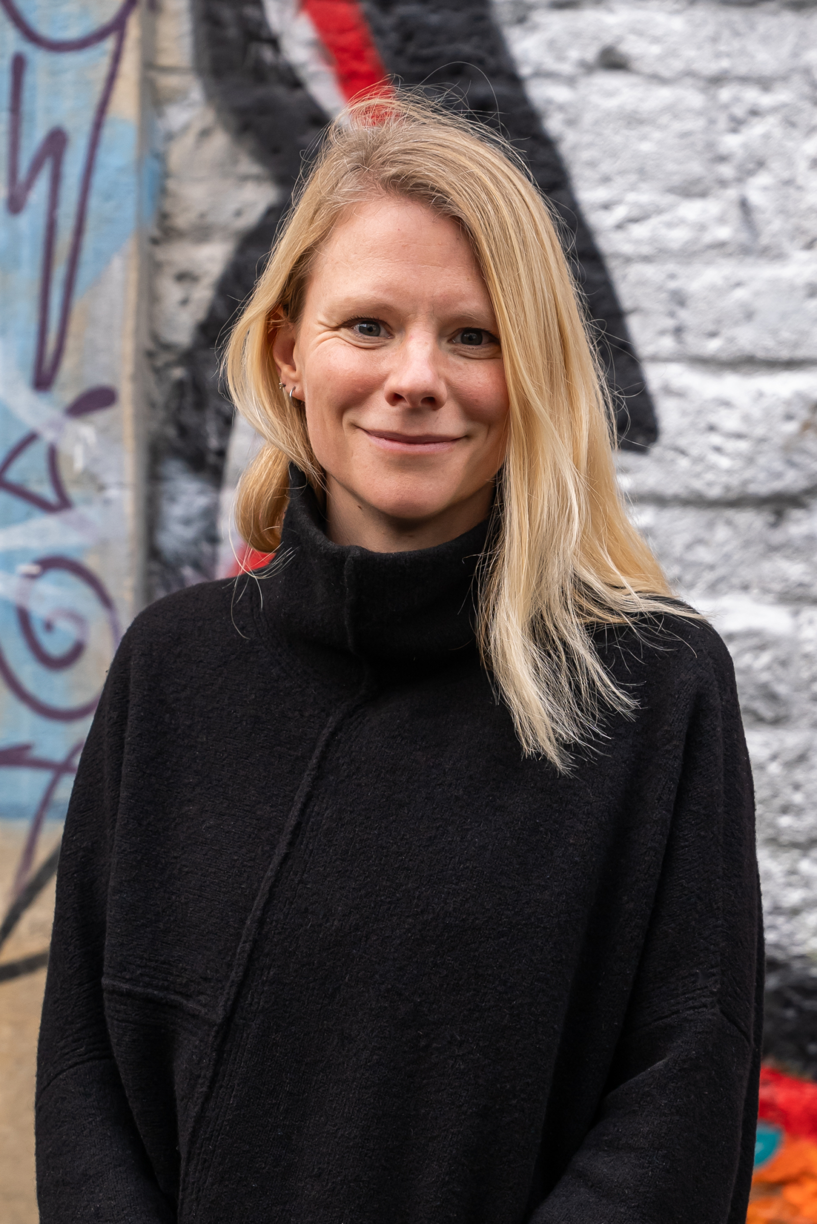 Dr Kelly Neaves in front of street art. Beeston Media video production bristol science and technology video production higher education video production.