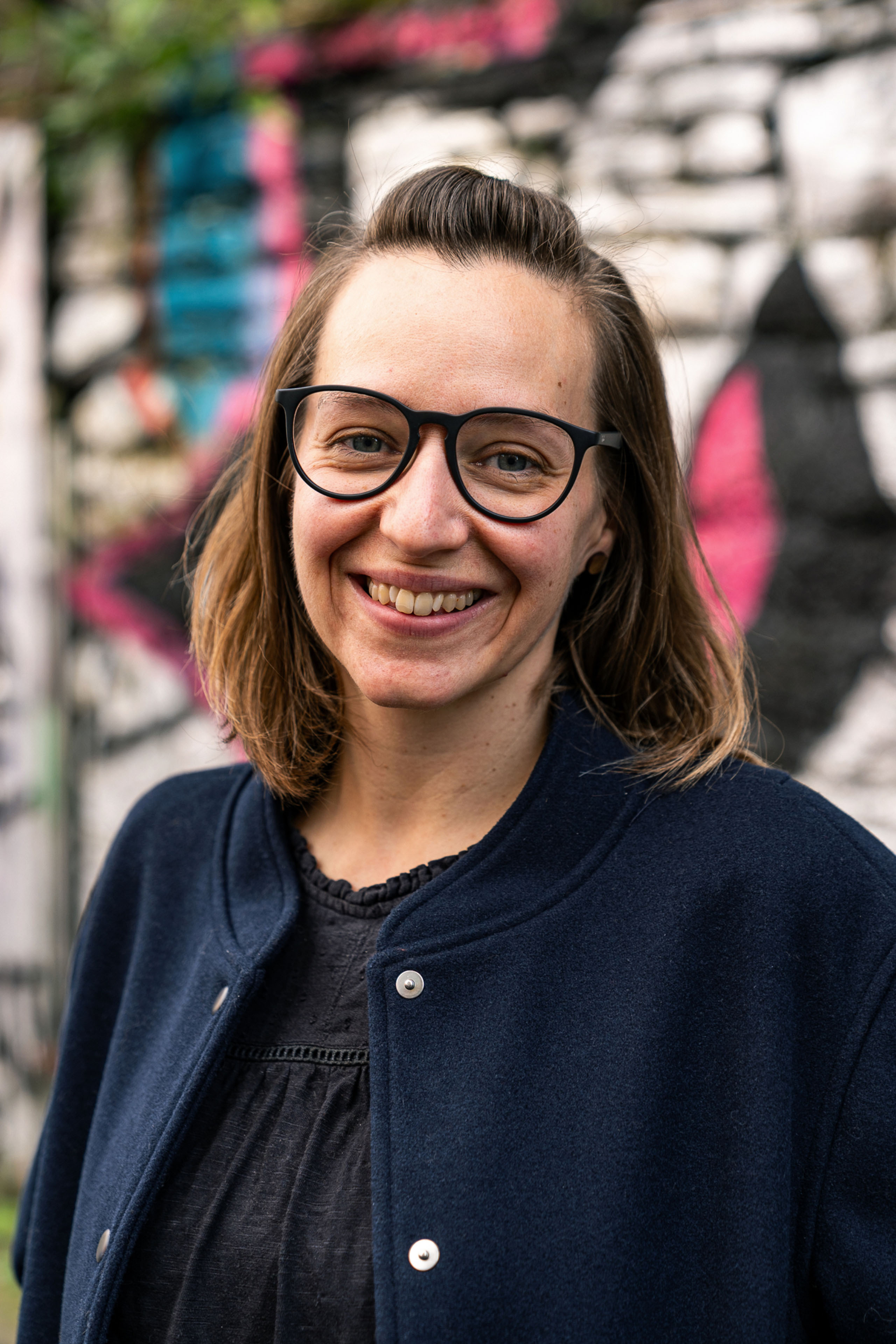 Dr Kim Bartholomew in front of street art. Beeston Media video production bristol science and technology video production higher education video production.