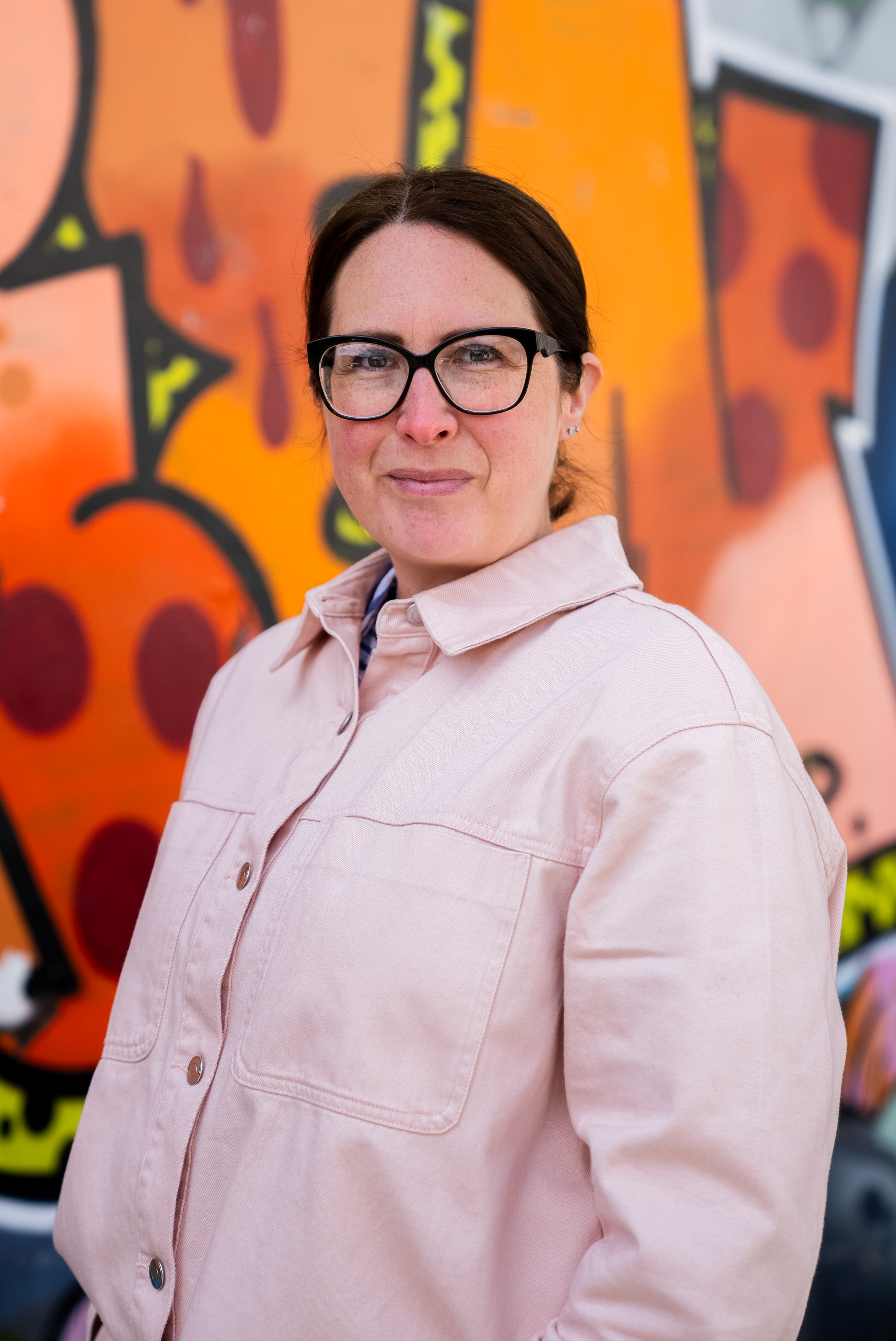 Nicky Burns in front of street art. Beeston Media video production bristol science and technology video production higher education video production.