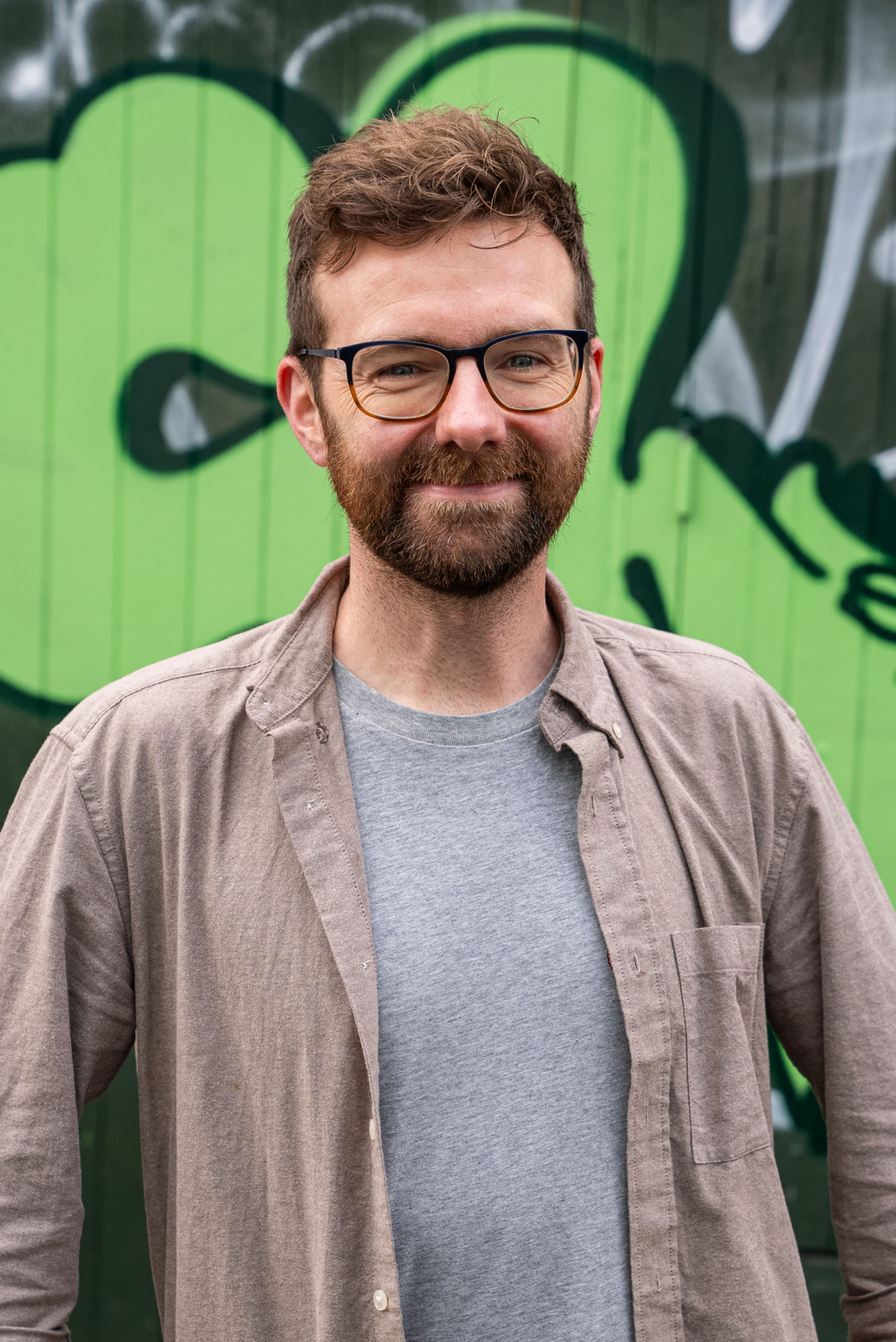Tom Stratford in front of street art. Beeston Media video production bristol science and technology video production higher education video production.