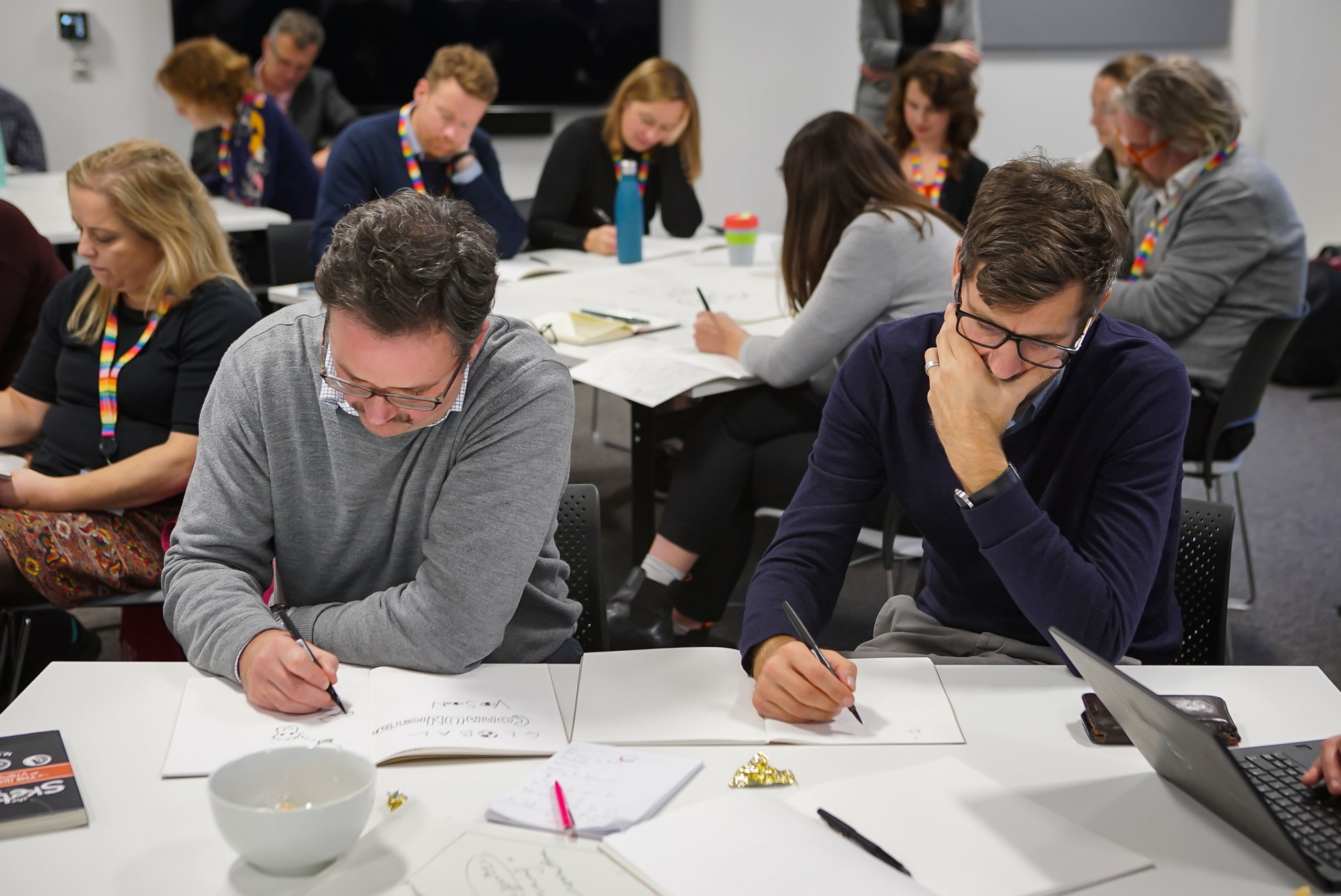Still of men writing at event for Temple Quarter Enterprise Campus, University of Bristol staff. Beeston Media property and design video production, Bristol video production.