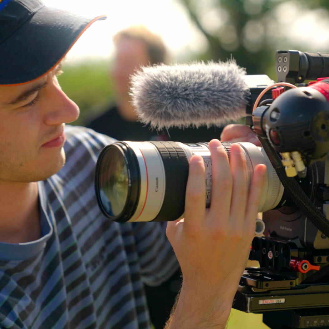Joe Astill changes a camera lens on Paul Lamb shoot. Beeston Media video production Bristol, science and technology video production, higher education video production.