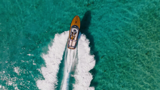 Aerial shot of speedboat from Lion House Albany, Bahamas film. Beeston Media property and design video production, Bristol video production.